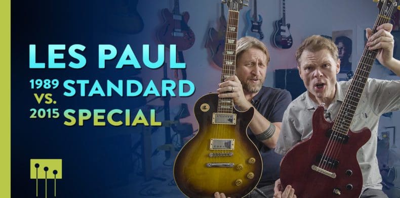 men holding two les paul electric guitars